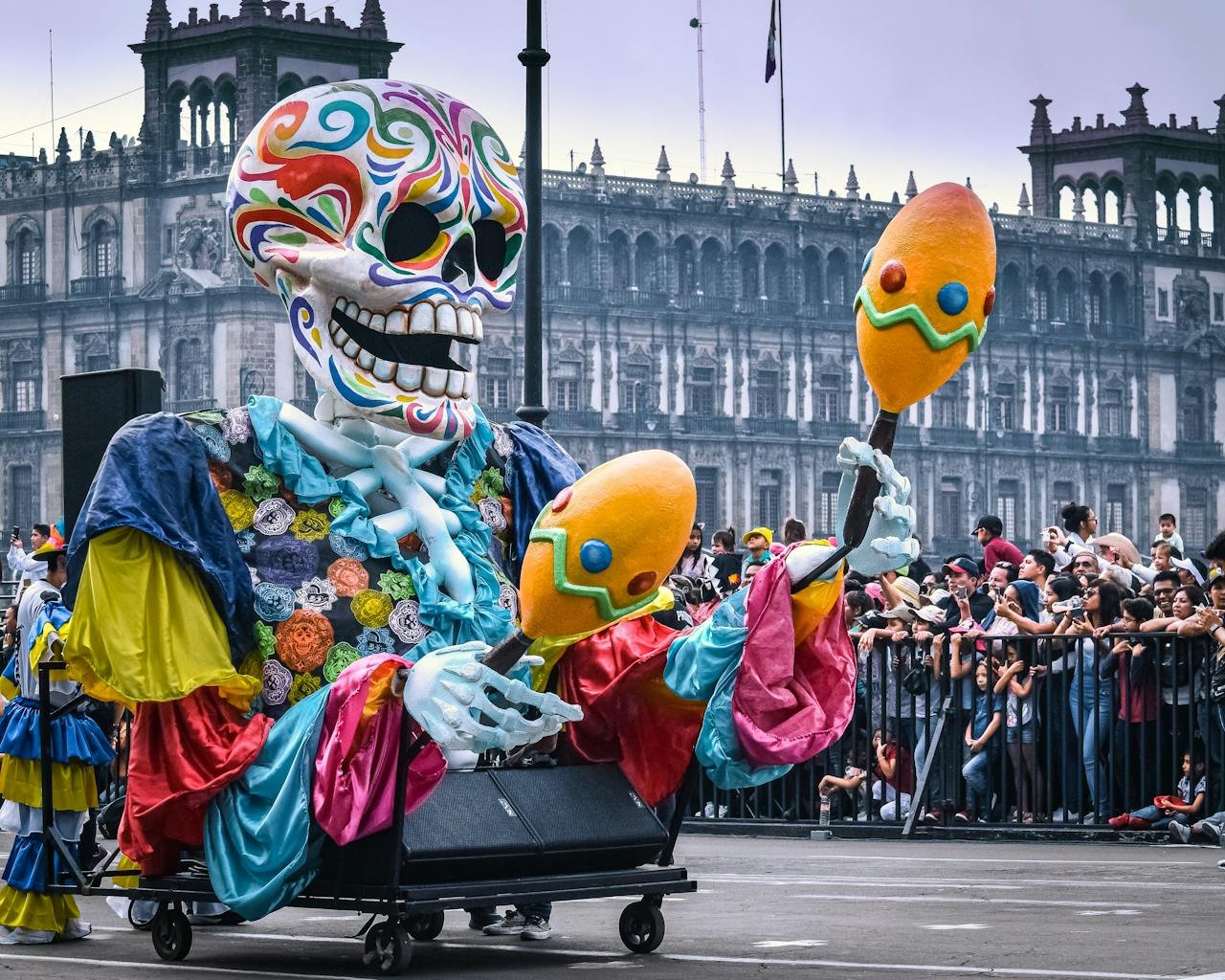 Vibrant Day of the Dead parade with a festive skeleton float in Mexico City.