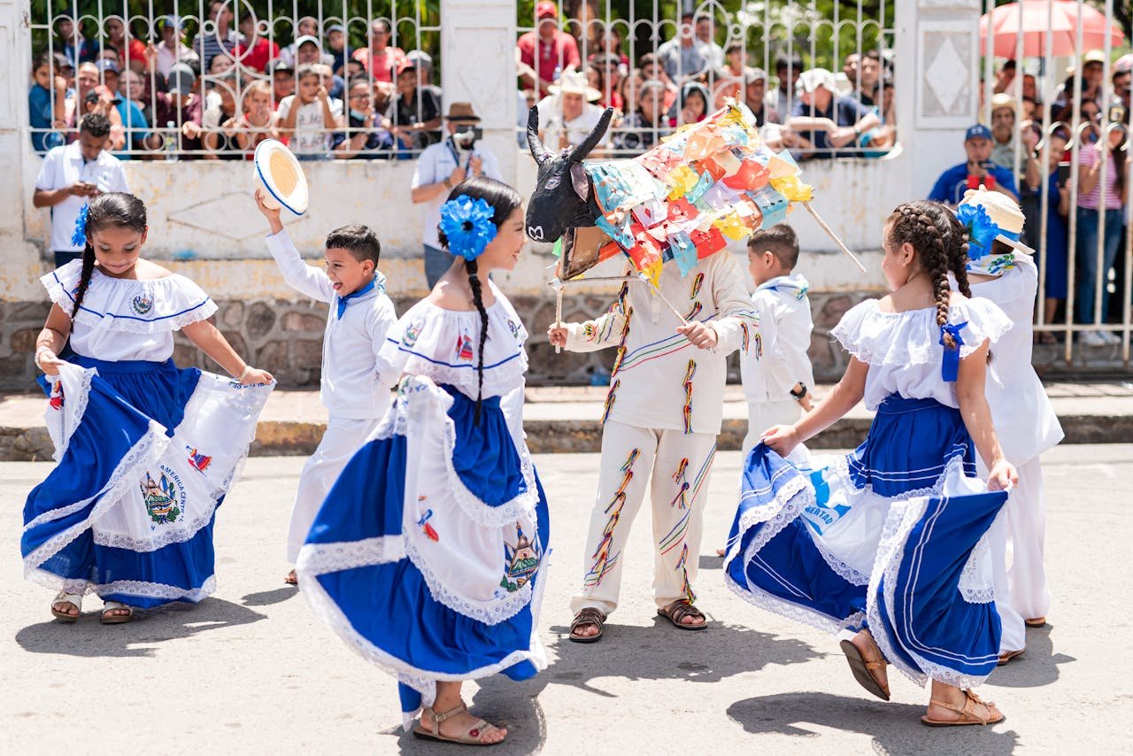 Kids in vibrant traditional outfits perform a cultural dance in Santa Rosa de Lima, El Salvadors festival.